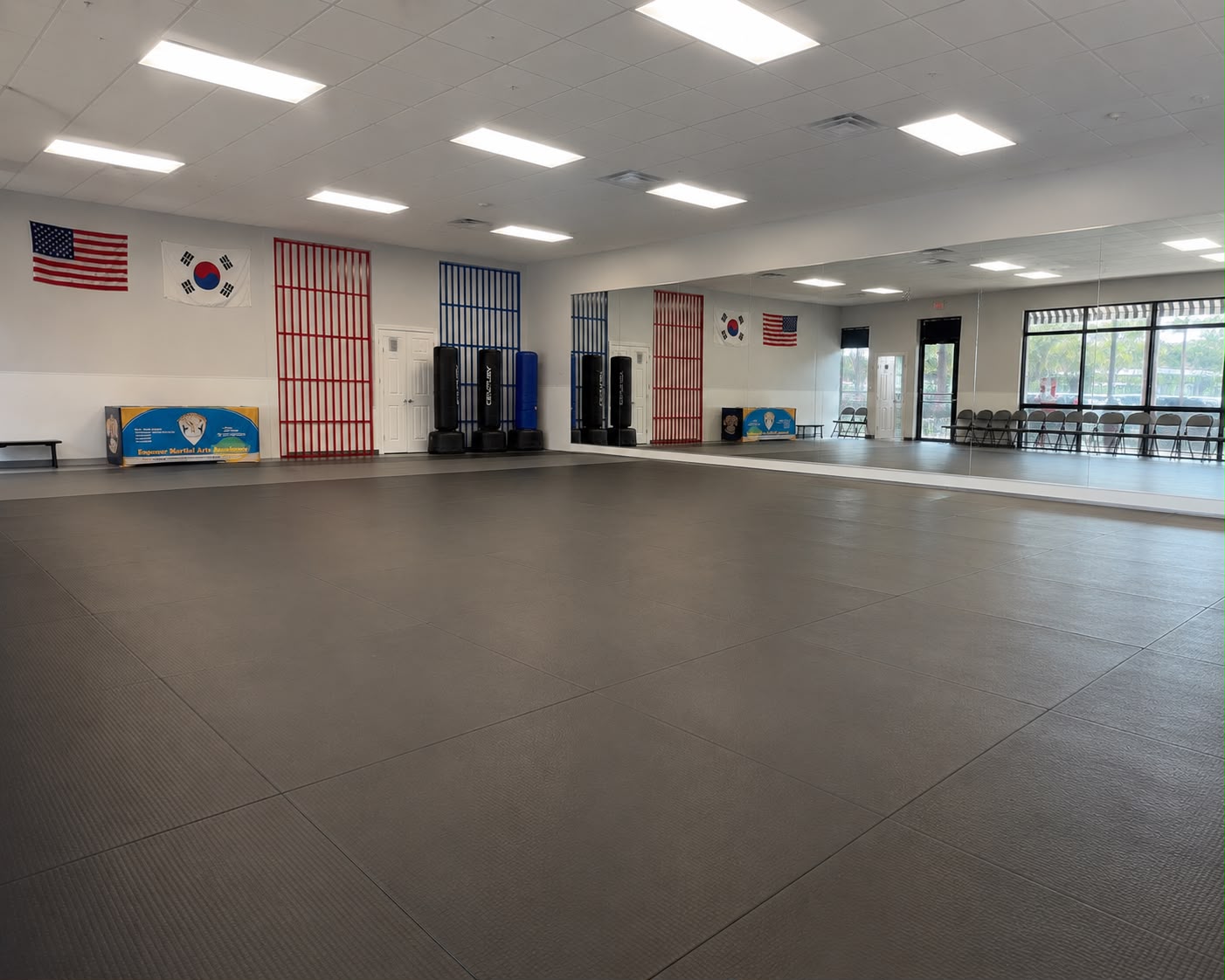 Large matted martial arts training floor with mirrors at Empower Martial Arts Academy Lake Worth