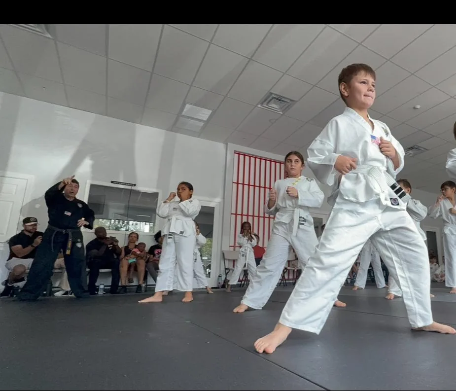 Empower Martial Arts student board break with instructor
