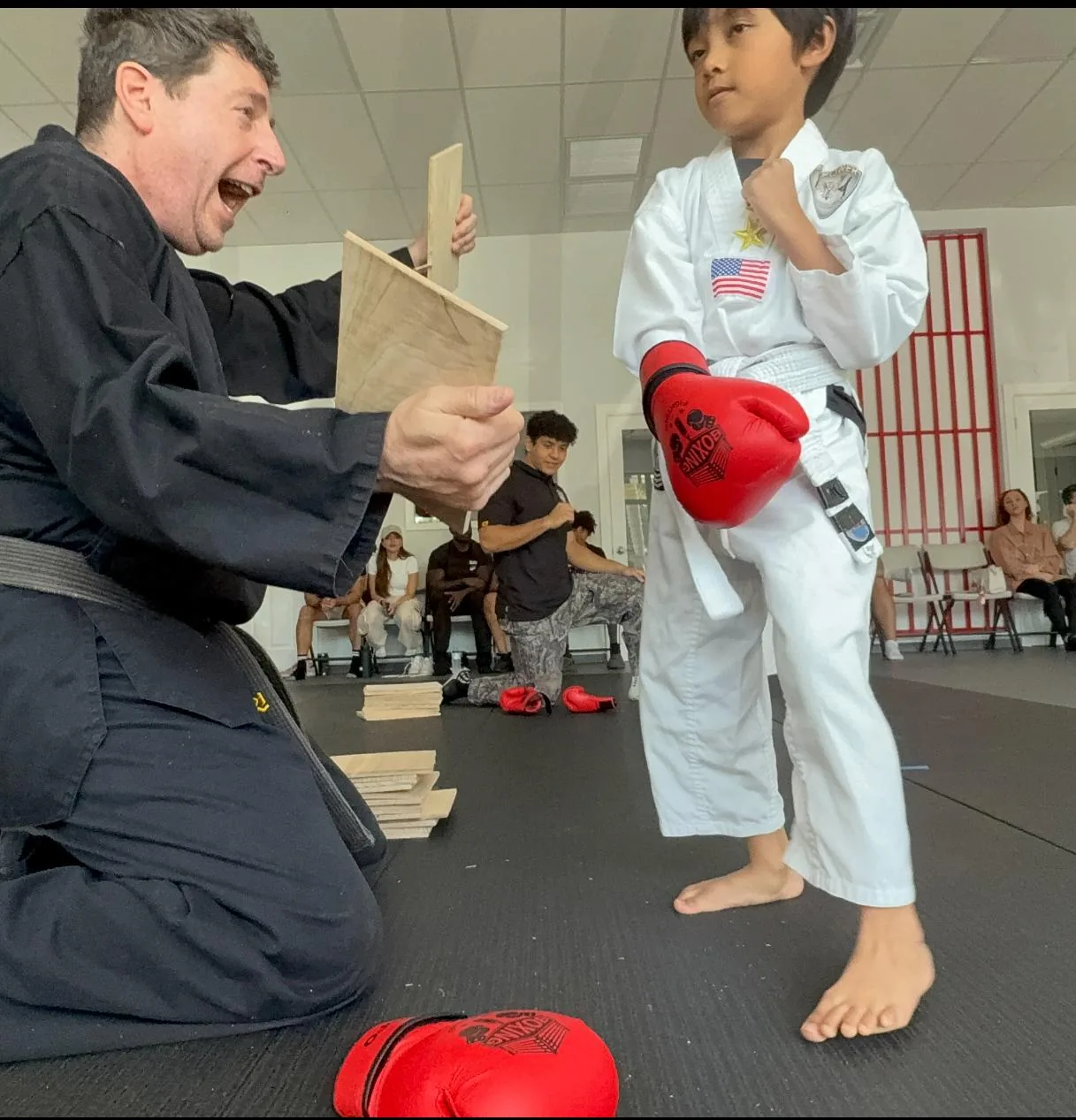 Student receiving belt from Master at Empower Martial Arts