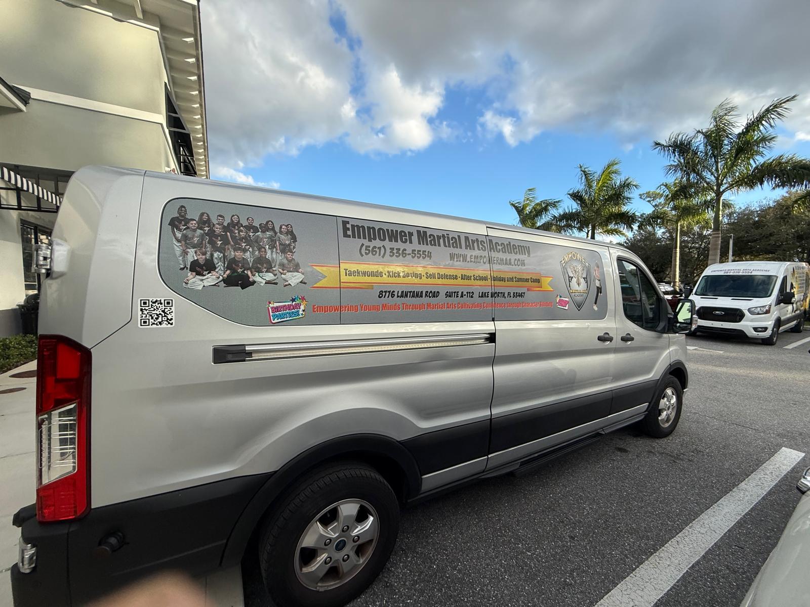 Empower Martial Arts Academy children transportation van #2 — silver long passenger Ford Transit van with academy branding, used for after school program pickup in Lake Worth FL