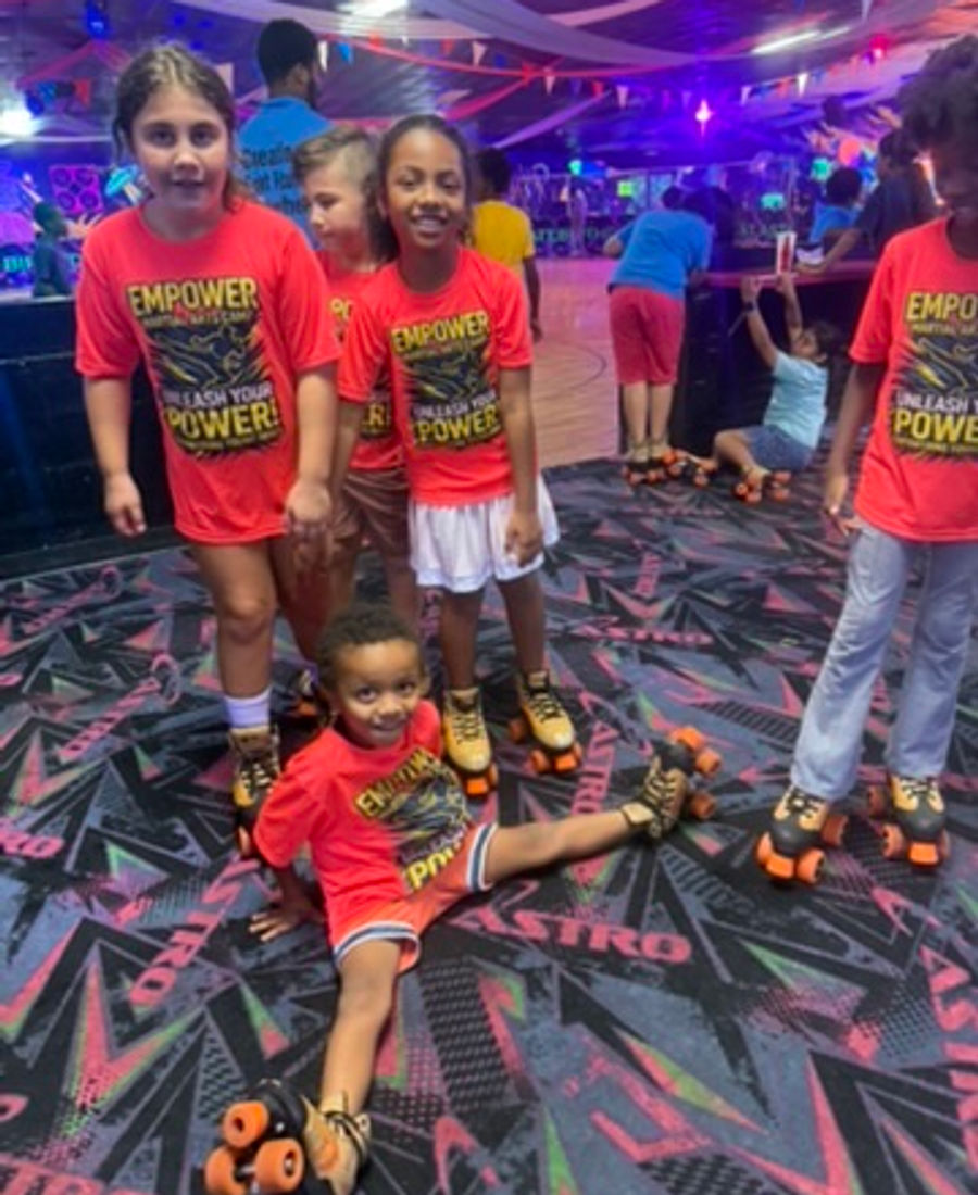 Kids roller skating activity during Empower Martial Arts camp